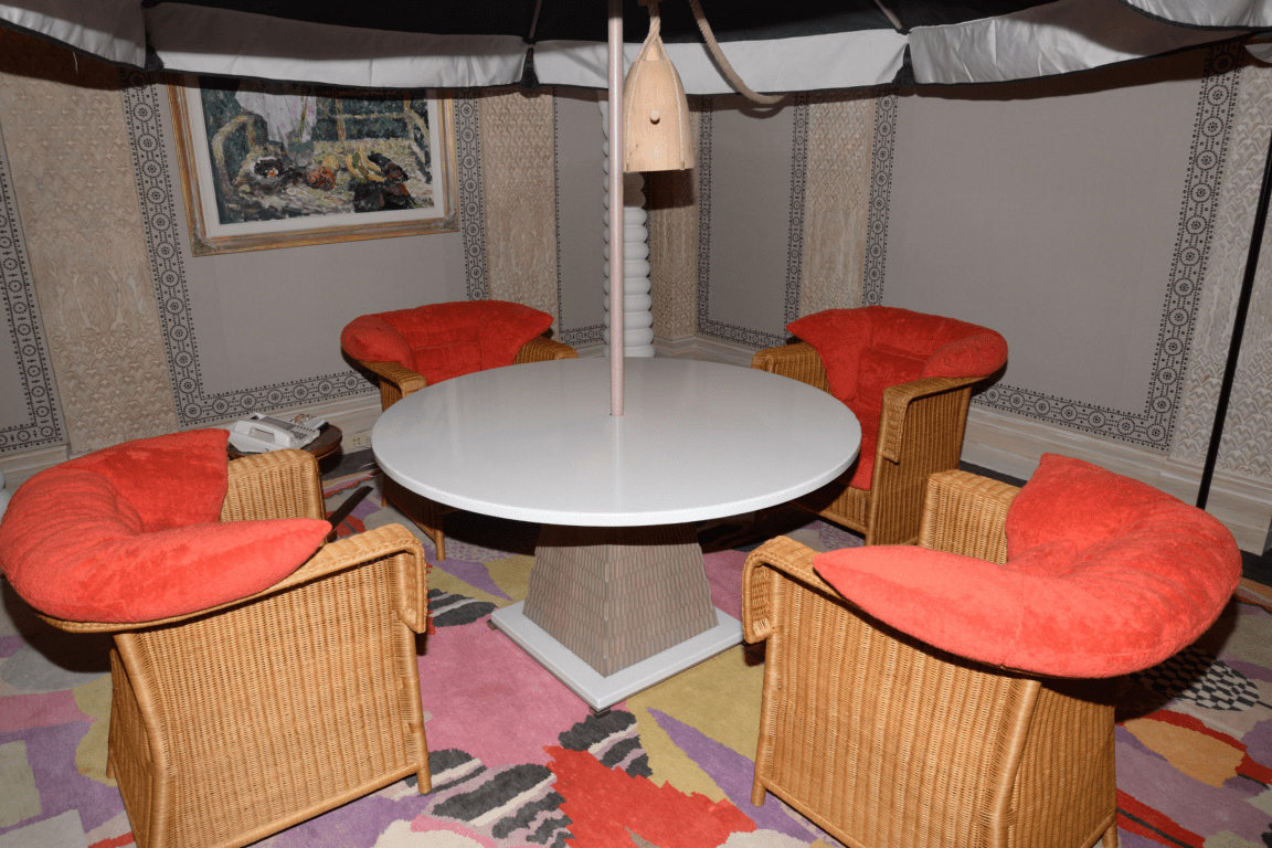 EFTA00001006 - Cozy retro-style room features four wicker chairs with vibrant red cushions
